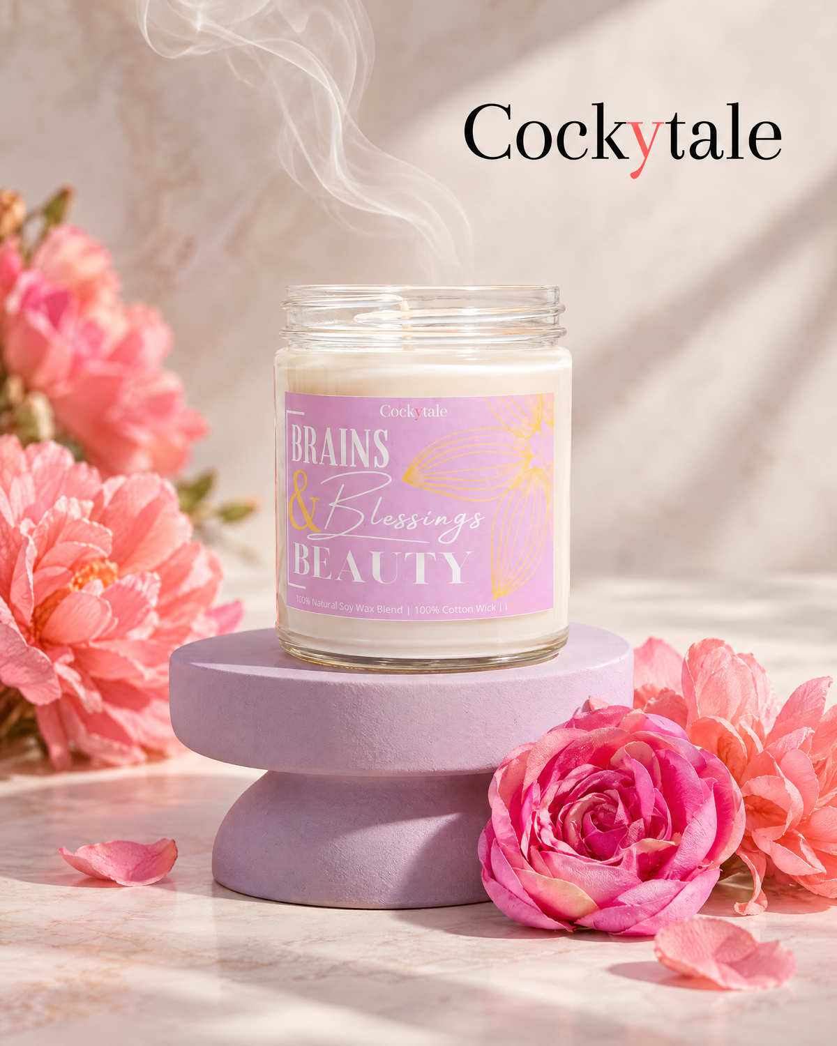 A jar candle labeled 'Brains, Blessings, Beauty' by Cockytale sits on a lavender pedestal, surrounded by pink flowers on a light marble surface with steam rising from the wax.